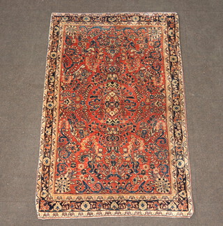 A Sarout pink and red ground Persian rug with central medallion 157cm x 101cm 
