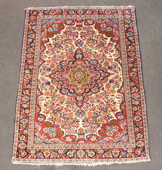 A blue, white and red ground and floral patterned Persian rug with central medallion 205cm x 152cm  