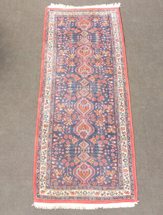 A blue, red and white ground Persian runner, floral patterned, stylised medallions to the centre 250cm x 95cm 