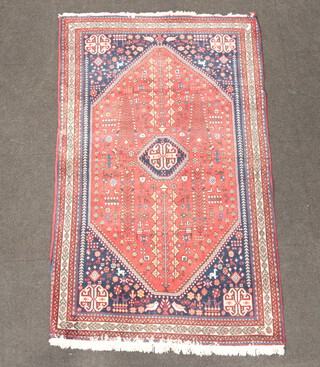 A blue and tan ground Persian rug with medallion to the centre within a multi row border 163cm x 103cm  