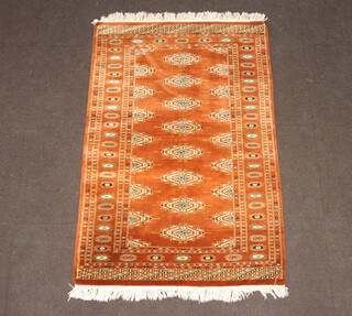 A brown and green ground Bokhara rug with 8 diamonds to the centre 147cm x 99cm 