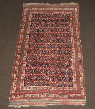A blue, white and red ground Persian rug with geometric design to the centre with a multi row border 274cm x 157cm  