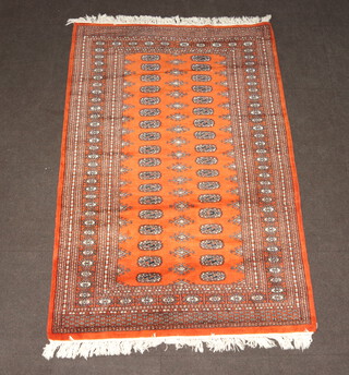 A brown and black ground Bokhara rug with 36 octagons to the centre  192cm x 128cm 