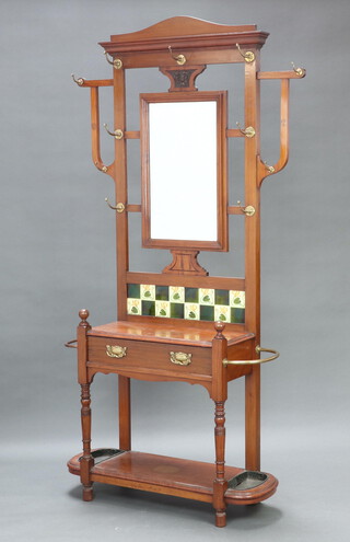 An Edwardian Art Nouveau walnut hall stand with rectangular bevelled mirror to the centre, the base fitted a drawer, complete with metal drip trays 212cm h x 107cm w x 35cm d 