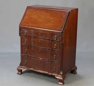 A Georgian style mahogany bureau of shaped outline and with canted corners, the fall front revealing a well fitted interior above 4 drawers, raised on ogee bracket feet 94cm h x 69cm w x 44cm d  