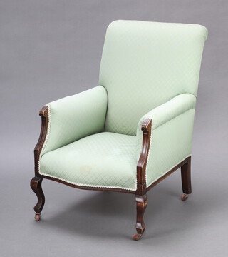 An Edwardian show frame mahogany armchair upholstered in green material, raised on cabriole supports 91cm h x 61cm w x 64cm d (seat 26cm x 22cm) 