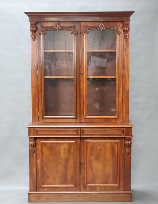 A Victorian mahogany bookcase on cabinet with moulded cornice, fitted adjustable shelves enclosed by glazed panelled doors, the base fitted 2 secret drawers above double cupboard enclosed by panelled doors 227cm h x 127cm w x 49cm d 