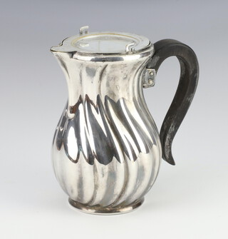 A Continental white metal jug with wooden handle 12cm 