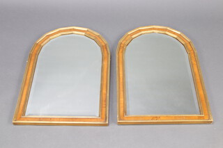 A pair of 19th Century style arched bevelled plate mirrors contained in walnut and gilt painted frames 69cm h x 45cm w  