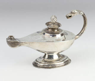 A silver cigar lighter in the form of a oil lamp with eagle handle and pineapple finial, Birmingham 1916, with presentation inscription 152 grams, 15cm 