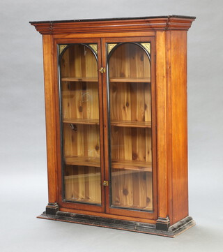 An Edwardian mahogany "shop" fitting with moulded cornice, fitted shelves enclosed by pair of arched heavy glass panelled doors, the base with brushing slide 127cm h x 99cm w x 34cm d 