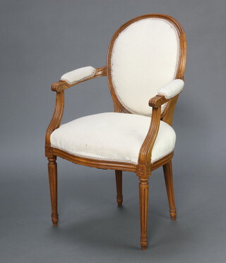 A 1930's French style beech open arm salon chair, the seat and back upholstered in white material, raised on turned and fluted supports 95cm h x 59cm w x 40cm d 