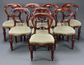 A set of 8 Victorian style carved mahogany balloon back dining chairs with shaped and pierced mid rails, overstuffed seats, raised on turned supports 90cm h x 48cm w x 41cm d 