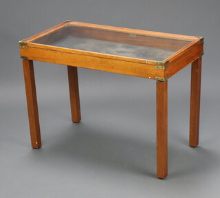 A rectangular bleached mahogany campaign style bijouterie table with hinged lid, raised on square supports 63cm h x 87cm w x 46cm d 