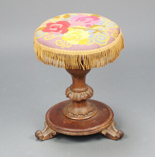 A Victorian bleached mahogany circular revolving adjustable piano stool with wool work seat, raised on turned column, splayed feet 45cm h x 34cm diam. 
