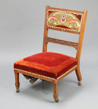 James Shoolbred and Company, a Victorian carved oak show frame nursing chair with upholstered back 76cm h x 49cm w x 45cm d 
