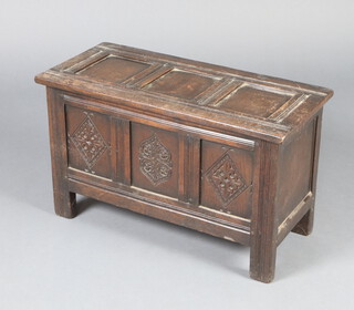 A 1930's oak 17th Century style carved oak coffer of panelled construction with hinged lid 40cm h x 67cm w x 31cm d, the back marked G T Rackstraw Ltd 