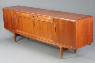 A large and impressive teak sideboard fitted 2 long drawers above cupboard enclosed by a tambour shutter flanked by cupboards enclosed by panelled doors, raised on shaped supports 86cm h x 238cm w x 51cm d 