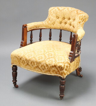 A Victorian mahogany tub back chair with spindle decoration, upholstered in yellow  material 65cm h x 56cm w x 62cm d  