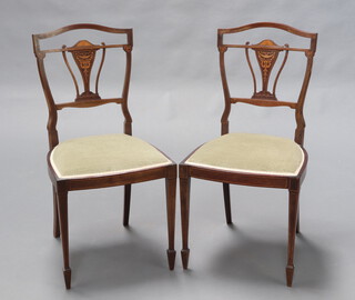 A pair of Edwardian inlaid mahogany slat back bedroom chairs, the seats upholstered in green material raised on tapered supports, spade feet 87cm h x 44cm w x 44cm d 
