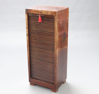 A 1930's mahogany filing cabinet fitted drawers enclosed by a tambour shutter 115cm h x 48cm w x 36cm d 