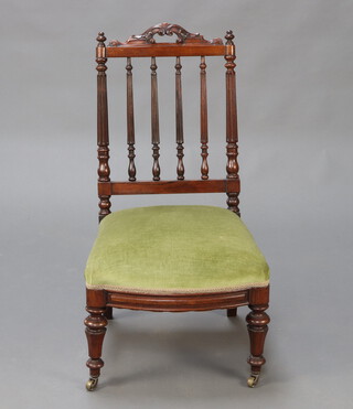 A Victorian rosewood stick and rail back dining chair with carved and pierced cresting rail, turned fluted columns, overstuffed seat, raised on turned supports 91cm h x 49cm w x 48cm d 