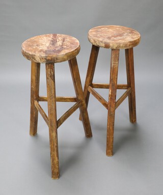 A pair of circular elm stools raised on square supports 77cm h x 32cm diam. 