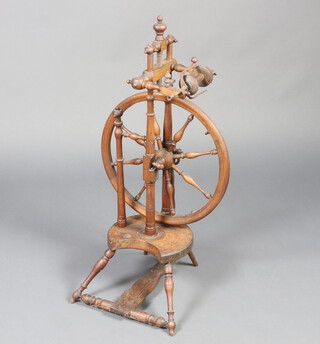 A turned walnut spinning wheel 87cm h x 27cm w x 37cm d 