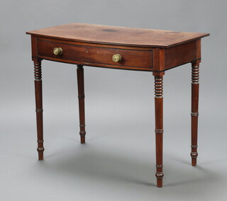 A Georgian mahogany bow front side table fitted a frieze drawer, raised on ring turned supports 76cm h x 93cm w x 51cm d 