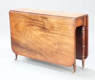 A 19th Century mahogany drop flap dining table raised on turned supports, brass caps and casters 70cm h x 106cm w x 27cm 