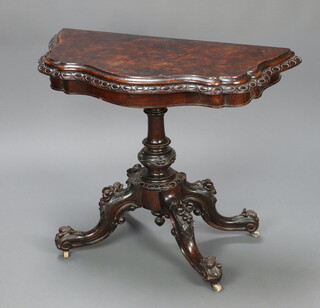 A Victorian walnut card table of serpentine outline raised on turned carved column and tripod base 76cm h x 96cm w x 44cm d 