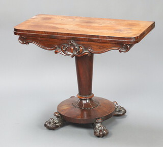 A William IV rosewood card table raised on a turned column, circular base, paw feet 75cm h x 91cm w x 45cm d 