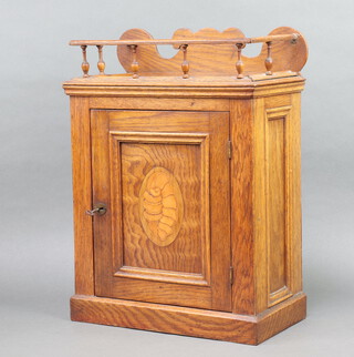 An Edwardian inlaid mahogany smokers cabinet with galleried top, interior fitted a drawer enclosed by panelled door, raised on a platform base 47cm h x 35cm w x 19cm d 