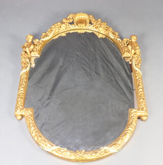 A 19th/20th Century arched bevelled plate mirror contained in a decorative gilt plaster frame surmounted by a shell and with cherubs to the sides 104cm x 74cm 