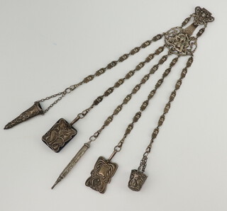 A Victorian silver plated chatelaine decorated with a lady, having attachments, scissor case, pencil, pin holder, pin holder, aide memoire 