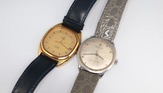 A gentleman's vintage Omega de Ville quartz calendar wristwatch contained in a 32mm gilt case case together with a gentleman's Hamilton automatic steel cased wristwatch the dial inscribed Pan Europ contained in a 30mm case, both on leather straps 