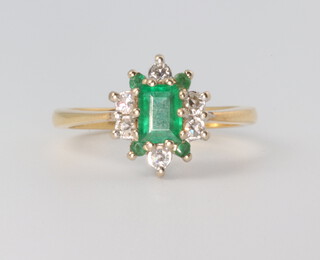 An 18ct yellow gold emerald and diamond cluster ring, the centre stone approx. 0.5ct, the diamonds approx. 0.20ct, size N, 3.8 grams 
