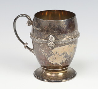 A silver Arts and Crafts mug with strap work decoration and fancy handle, Birmingham 1931, maker Alexander Clarke and Co. 202 grams, 10cm  