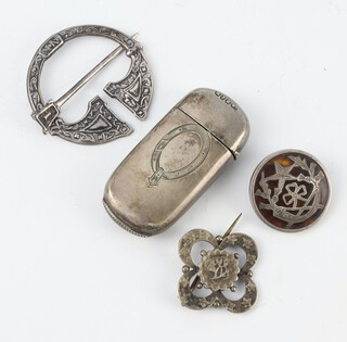 A Scottish white metal brooch, 2 others and a vesta 