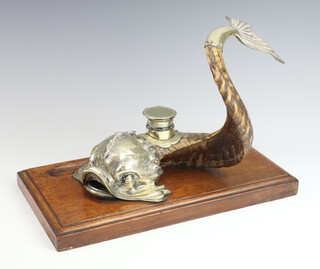 A Victorian ink stand in the form of a dolphin with plated mounts and tail on a rams horn body, having an inkwell with glass base mounted on an oak plinth with pen scoop, 32cm  