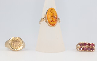 A 9ct yellow gold amber ring, a ditto garnet ring and a coin set ring, gross weight 7.7 grams, sizes H, L and M 