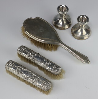 A pair of silver dwarf candlesticks Birmingham 1990 7cm (1 dented) together with a silver backed hair brush and 2 clothes brushes 