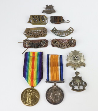 A British War medal to G/24057 Pte.E.A.Roberts R.Suss.R and a Victory medal to 49113 Pte.W.E.Roberts BEDF.R together with minor cap badges