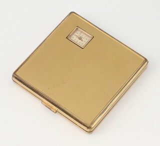 An Art Deco gilt square compact with visible watch, the dial inscribed Weldwood 