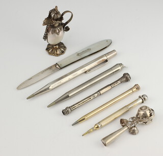 A white metal rattle whistle, 5 pencils and 2 other items 
