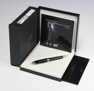 A Mont Blanc Diamond ballpoint pen, the top mounted by a 0.06ct G colour and SI clarity diamond, the lid engraved R E Bird, boxed with original certificate and outer box  