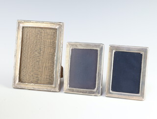 A rectangular silver photograph frame 14cm x 10cm Birmingham 1947, a pair of rectangular ditto 10.5cm x 8cm Sheffield 1982/86