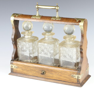 A Victorian oak and silver plated 3 bottle tantalus (one decanter is chipped) 28cm x 36cm x 13cm 