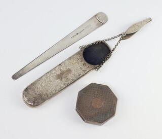 A Victorian silver engraved spectacle case holder with clip and chain, a paper knife and a compact, gross weight 90 grams