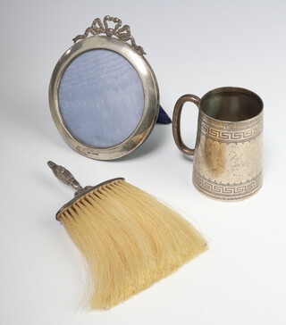 A Victorian silver christening mug Chester 1899, a ditto circular photograph frame 1906 and a silver mounted brush 1902 